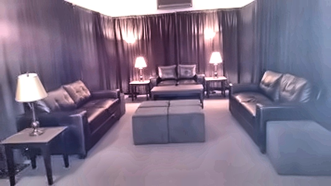 Leather lounge seating with pipe and drape backdrop